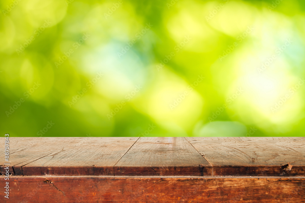 Poster empty wooden table and green natural spring blur bokeh backgroun