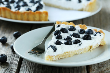 Sweet tart cake with blueberries on grey wooden background