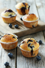 Tasty blueberry muffins on a grey wooden background