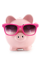 Pink piggy bank with glasses isolated on a white