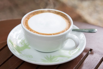 cup of coffee on wooden