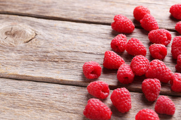 Red raspberries on grey wooden background
