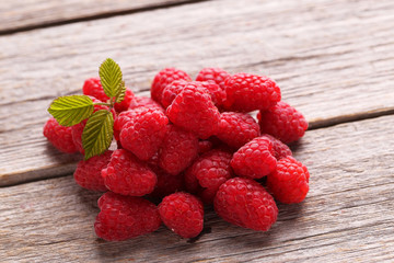 Red raspberries on grey wooden background