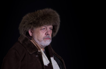 Portrait of tough senior man in winter clothes