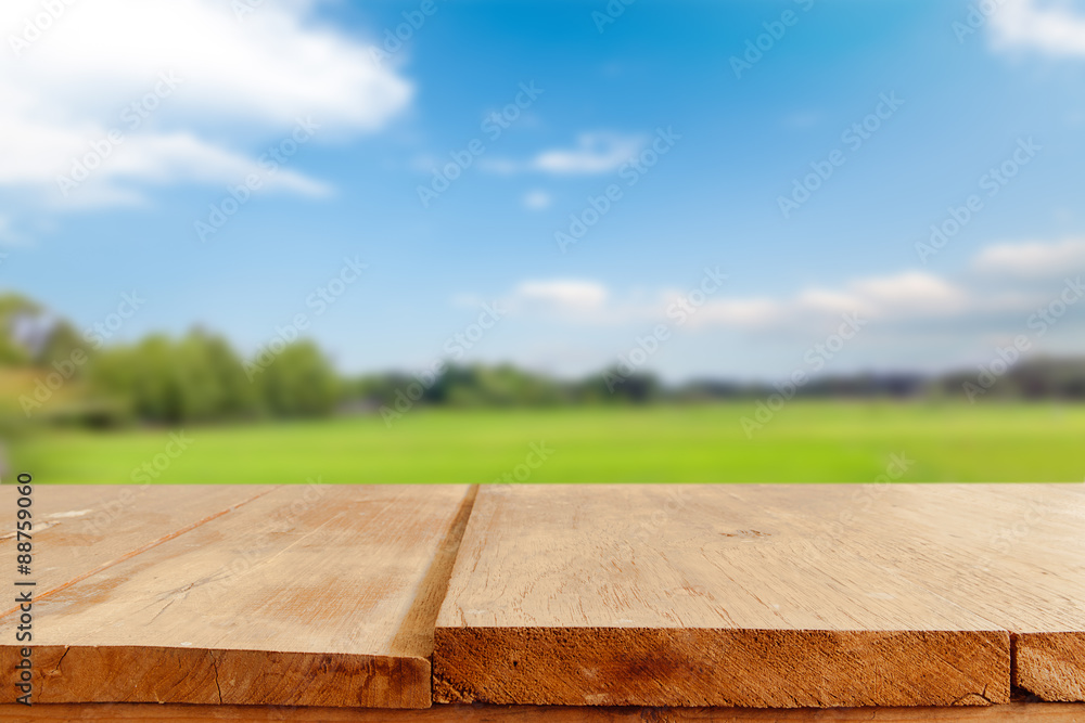Poster empty table and field of grass and perfect sky background