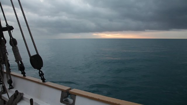 Sunrise at Mediterranean sea from ancient  sailboat deck
