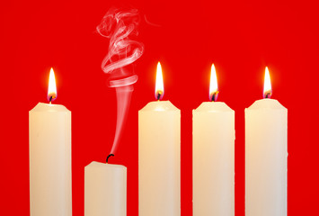 Row of candles with one extinguished