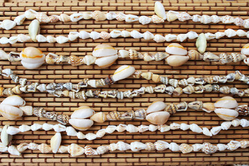 Cowrie shell necklaces in the bamboo background (symbol of money and wealth)