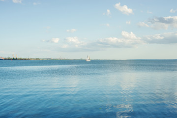 Obraz premium blue river and clouds on sunset with white yacht