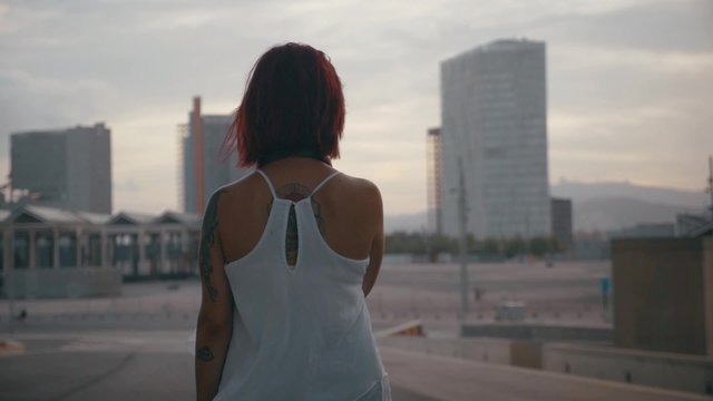 Woman looking at the city and buildings in slow motion