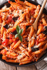 Pasta alla Norma. Penne with eggplant and tomatoes vertical
