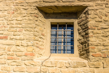 Fototapeta na wymiar Iron grating window on brick wall