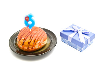 donut with six years birthday candle and gift