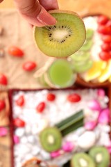 Obraz na płótnie Canvas Oat flakes with fruit, kiwi, orange, tomato and kiwi juice.