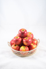 red apple in wooden basket