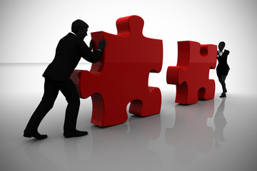 Executives connecting jigsaw puzzle pieces. A team of two executives connecting jigsaw puzzle pieces into position demonstrate teamwork .