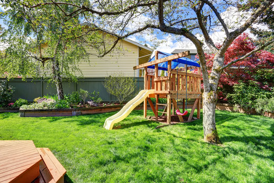 Perfect Play Set In Back Yard Of Modern Home.