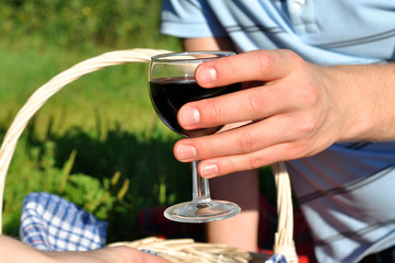 Hands holding glasses of red wine