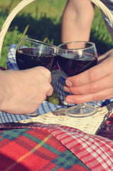 Fototapeta na wymiar Hands holding glasses of red wine