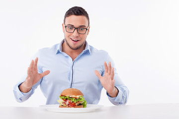 Cheerful young fit man is very hungry