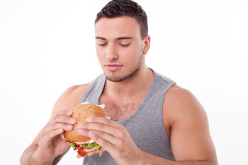 Attractive young guy is refusing to eat unhealthy food