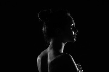 Fototapeta na wymiar beautiful young woman in dark studio closeup