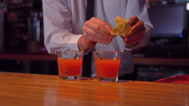 Bartender pouring cocktails on counter