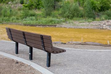 Empty bench along the toxic Animas River after a toxic mine spill caused by the EPA