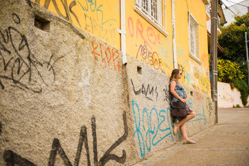 Young pregnant woman standing in a wall in Valparaiso