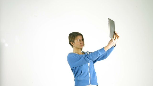 Pretty girl taking selfie with tablet pc