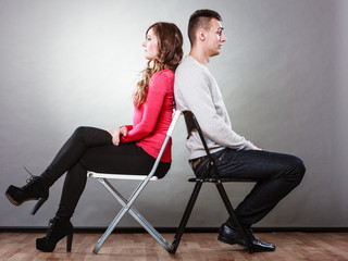 Young couple after quarrel sitting back to back