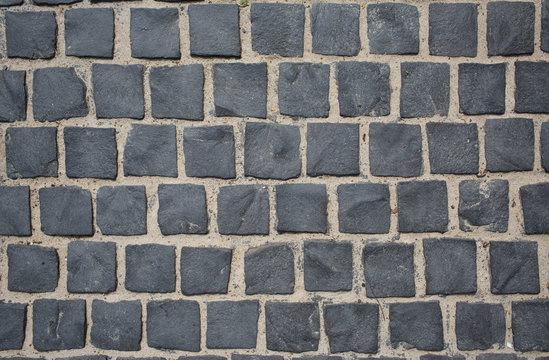 Gray old paving stone closeup