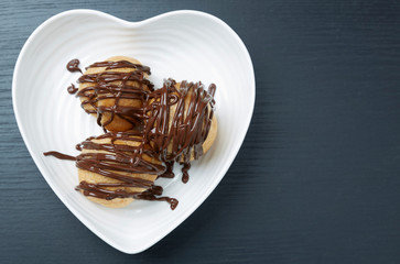 Three Pastries with Chocolate Sauce on a Plate