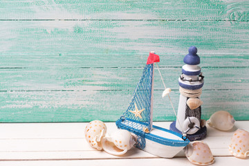 Fototapeta na wymiar Decorative lighthouse, sailing boat and marine items