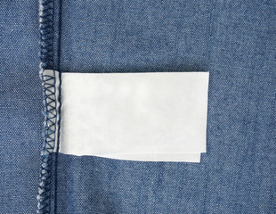 macro of blank tag on blue jeans background