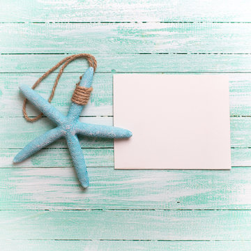 Marine item and tag on turquoise wooden background.