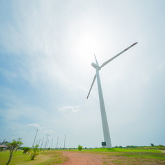 Fototapeta premium Field of white wind turbines generating electricity