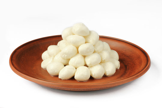 Baby mozzarella balls on a plate isolated on white background