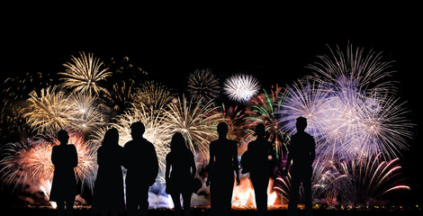 Group of people looks beautiful colorful holiday fireworks