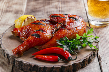 Grilled  half chicken barbecue on a wooden surface