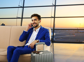 Business man with suitcase in hall of airport