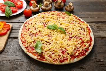 Food ingredients for pizza on table close up