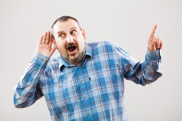 Portrait of man who is trying to hear something