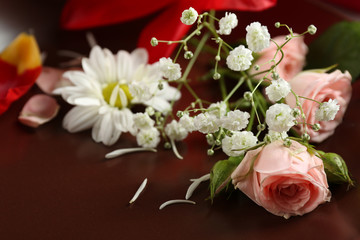 Tableware with flowers on table close up