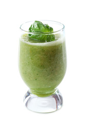 Glass of green healthy juice with basil isolated on white