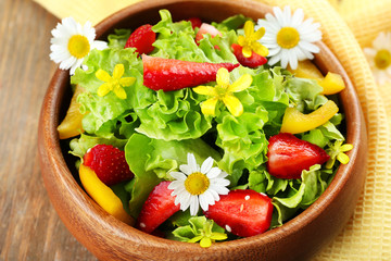 Light organic salad with flowers, close up