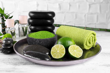 Beautiful composition of spa treatment on tray, on light background