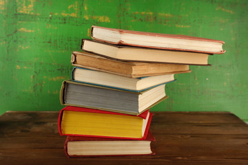 Stack of books on wooden background