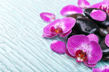 Fototapeta premium Violet orchid and zen stones close-up