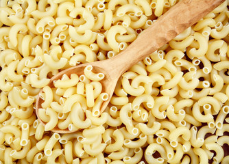 Raw Chifferi pasta with wooden spoon